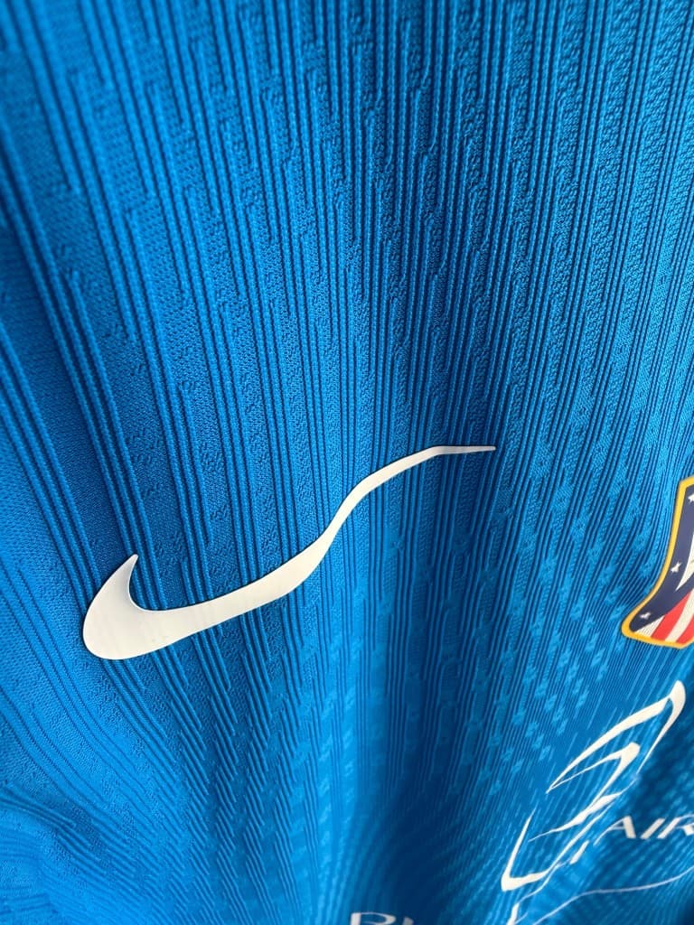 Nike swoosh detail on match-issued fabric